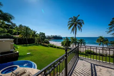 a balcony with a view of the beach at Elegant Mediterranean-Style Mansion with Beachfront Views and Private Infinity Pool in Playa Flamingo