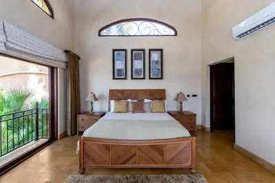 a bedroom with a bed and a large window at Elegant Mediterranean-Style Mansion with Beachfront Views and Private Infinity Pool in Playa Flamingo