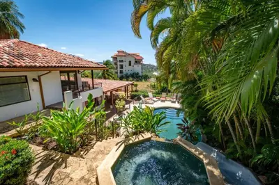 an image of a swimming pool in front of a house at Luxury Five-Bedroom Oasis in Playa Flamingo with a Private Pool and Stylish Decor in Playa Flamingo
