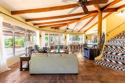 a living room with a couch and a ceiling fan at Luxury Five-Bedroom Oasis in Playa Flamingo with a Private Pool and Stylish Decor in Playa Flamingo