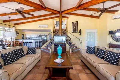 a living room with a couch and a table at Luxury Five-Bedroom Oasis in Playa Flamingo with a Private Pool and Stylish Decor in Playa Flamingo
