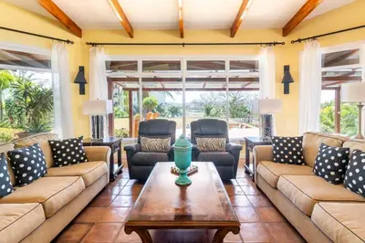 a living room with couches and a table at Luxury Five-Bedroom Oasis in Playa Flamingo with a Private Pool and Stylish Decor in Playa Flamingo