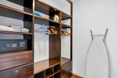 a wooden closet with a surfboard in it at Dreamy Spanish-Style Villa with Sweeping Ocean Views, Elegant Nautical Design & Giant Infinity Pool in Playa Flamingo