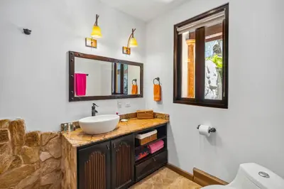 a bathroom with a sink and a mirror at Dreamy Spanish-Style Villa with Sweeping Ocean Views, Elegant Nautical Design & Giant Infinity Pool in Playa Flamingo