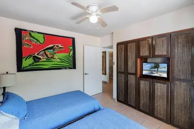 a bedroom with a bed and a flat screen tv at Charming Duplex in Playa Potrero Surfside Community, with a Private Pool, Cozy Interior and Walkable Access to the Beach in Potrero