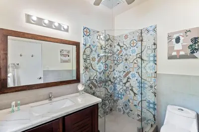a bathroom with a sink and a shower with a mirror at Charming Duplex in Playa Potrero Surfside Community, with a Private Pool, Cozy Interior and Walkable Access to the Beach in Potrero