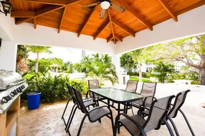 a patio with a table and chairs on it at Fifth-Floor Condo with Breathtaking Ocean Views, Stylish Interior & Prime Location Near Flamingo Beach in Playa Flamingo