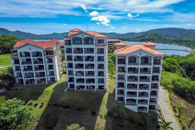 an aerial view of two apartment buildings with a lake at Fifth-Floor Condo with Breathtaking Ocean Views, Stylish Interior & Prime Location Near Flamingo Beach in Playa Flamingo