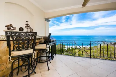 a room with a balcony with a view of the ocean at Fifth-Floor Condo with Breathtaking Ocean Views, Stylish Interior & Prime Location Near Flamingo Beach in Playa Flamingo