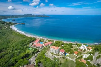 an aerial view of a resort next to the ocean at Fifth-Floor Condo with Breathtaking Ocean Views, Stylish Interior & Prime Location Near Flamingo Beach in Playa Flamingo