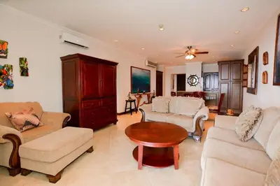 a living room with a couch and a table at Fifth-Floor Condo with Breathtaking Ocean Views, Stylish Interior & Prime Location Near Flamingo Beach in Playa Flamingo