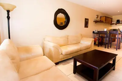 a living room with a couch and a table at Cozy Ground-Floor Condo with Community Pool, Rancho and Lush Garden Views in Brasilito