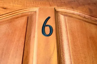 a wooden cabinet with the number six on it at Cozy Garden Condo with Vibrant Tropical Decor, Swimming Pool and Rancho in Brasilito