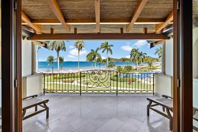 a balcony with a view of the beach at Upscale Two-Bedroom Condo in Playa Flamingo with Beautiful Oceanfront Views in Playa Flamingo