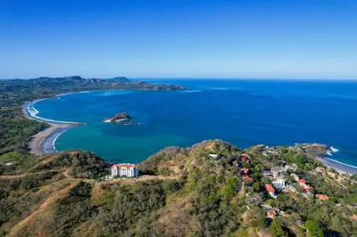 an aerial view of a small island in the ocean at Upscale Two-Bedroom Condo in Playa Flamingo with Beautiful Oceanfront Views in Playa Flamingo