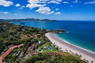 an aerial view of a beach and the ocean at Upscale Two-Bedroom Condo in Playa Flamingo with Beautiful Oceanfront Views in Playa Flamingo