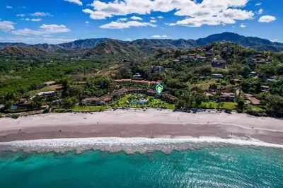 an aerial view of a beach with a resort at Upscale Two-Bedroom Condo in Playa Flamingo with Beautiful Oceanfront Views in Playa Flamingo
