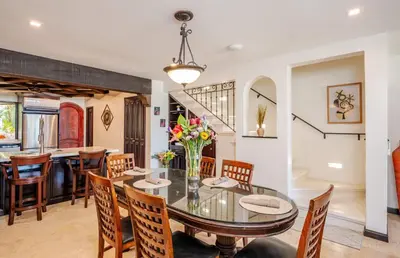 a dining room with a glass table and chairs at Upscale Two-Bedroom Condo in Playa Flamingo with Beautiful Oceanfront Views in Playa Flamingo
