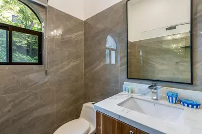 a bathroom with a sink and a mirror at Top-Floor Condo with Sweeping Ocean, Mountain & Marina Views in Playa Flamingo