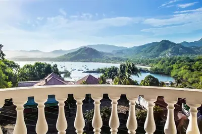 a balcony with a view of a river and mountains at Top-Floor Condo with Sweeping Ocean, Mountain & Marina Views in Playa Flamingo