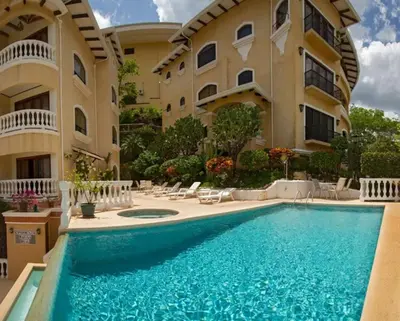 a swimming pool in front of a building at Top-Floor Condo with Sweeping Ocean, Mountain & Marina Views in Playa Flamingo