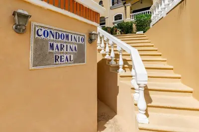 a sign on the side of a building with stairs at Top-Floor Condo with Sweeping Ocean, Mountain & Marina Views in Playa Flamingo