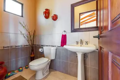a bathroom with a toilet and a sink at Big Hillside Villa in Potrero with Pool and Panoramic Ocean Views in Potrero