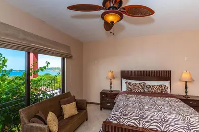 a bedroom with a bed and a ceiling fan at Big Hillside Villa in Potrero with Pool and Panoramic Ocean Views in Potrero