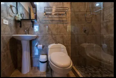 a bathroom with a toilet and a sink at Hotel Cabinas el Tecal in Uvita