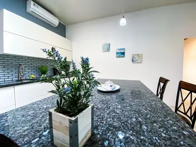 a kitchen with a table with a plant on it at Hotel Cabinas el Tecal in Uvita