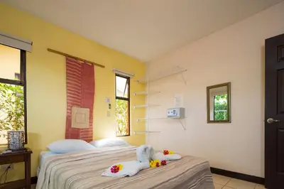 a bedroom with a bed with two stuffed animals on it at Playa Potrero Apartments in Potrero