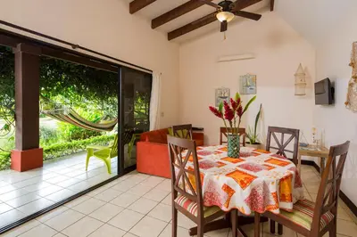 a dining room with a table and a couch at Playa Potrero Apartments in Potrero