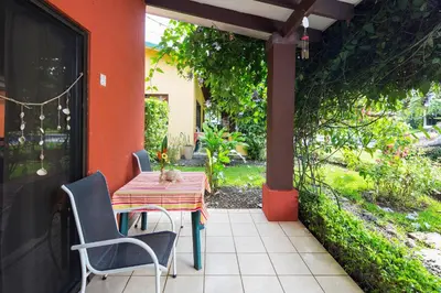 a table and chairs on the porch of a house at Playa Potrero Apartments in Potrero