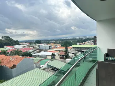 a view of a city from the balcony of a building at Charming Two Bedroom with balcony in San José