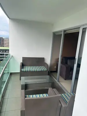 a balcony with a couch and a chair on a building at Charming Two Bedroom with balcony in San José