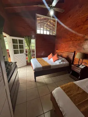 a bedroom with two beds and a ceiling fan at Hotel Bosque Verde Lodge in Monteverde Costa Rica