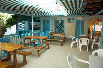 a group of tables and chairs on a patio at Hostel Samara in Sámara