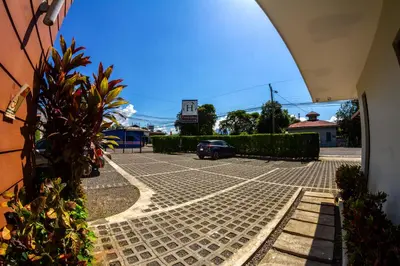 a car is parked in a parking lot at Hotel Iguana Verde in Orotina
