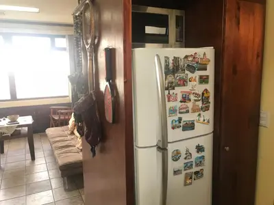 a refrigerator in a kitchen with magnets on it at Sofia Apartments in Escalante, San Jose Center in San José
