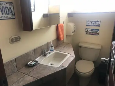 a bathroom with a toilet and a sink at Sofia Apartments in Escalante, San Jose Center in San José
