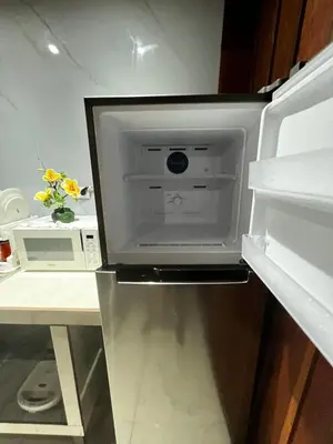 a refrigerator with its door open in a kitchen at Cabinas Lupita in Fortuna