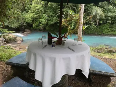 a table with a white table cloth on top of it at Cabinas Piuri in Rio Celeste