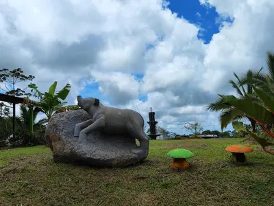 a statue of a koala sitting on a rock at Cabinas Piuri in Rio Celeste