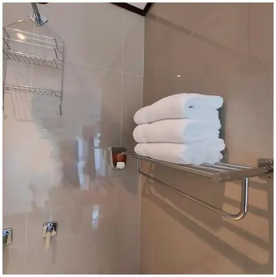 a pile of towels on a towel rack in a bathroom at Dreams Lodge in Monteverde Costa Rica