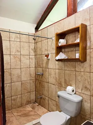 a bathroom with a toilet and a shower at Dreams Lodge in Monteverde Costa Rica