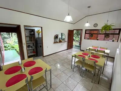 a dining room with yellow tables and red chairs at Dreams Lodge in Monteverde Costa Rica