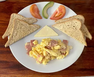 a plate of breakfast food with eggs and toast at Dreams Lodge in Monteverde Costa Rica