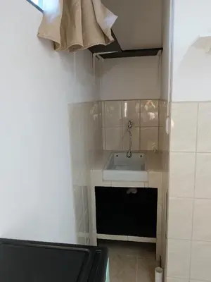 a small bathroom with a sink in a room at Cabinas Dormi Bene in Miramar