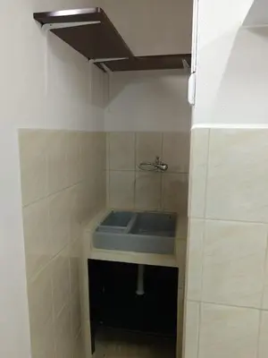 a small bathroom with a sink in the corner at Cabinas Dormi Bene in Miramar