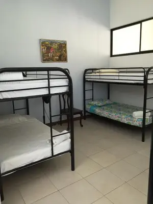 a room with three bunk beds and a window at Blue Morpho House B&B in Manuel Antonio